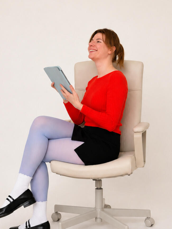 Vika Markouskaya seated with a tablet